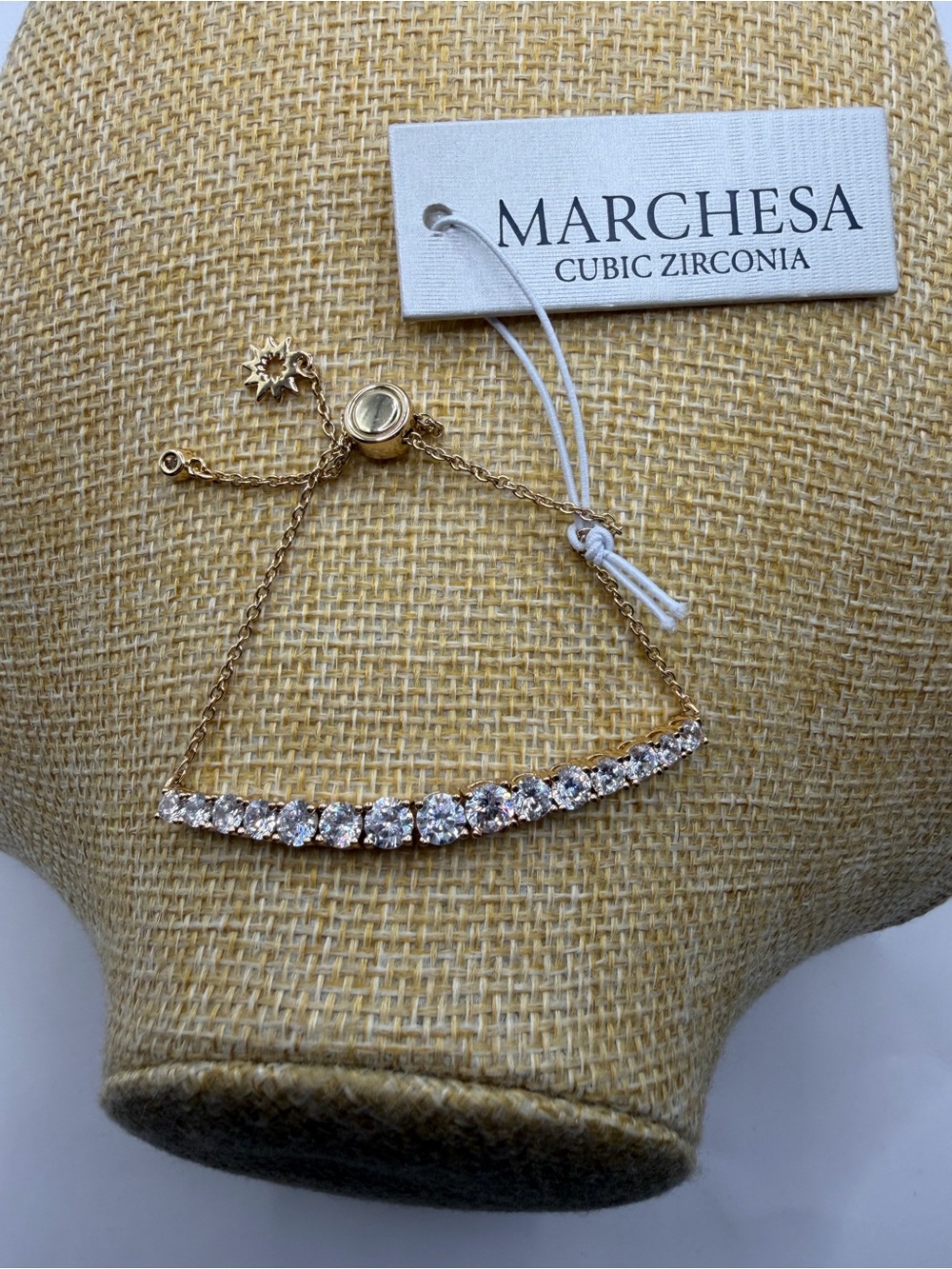 A Marchesa Cubic Zirconia gold-tone curved bar adjustable slider bracelet NWT